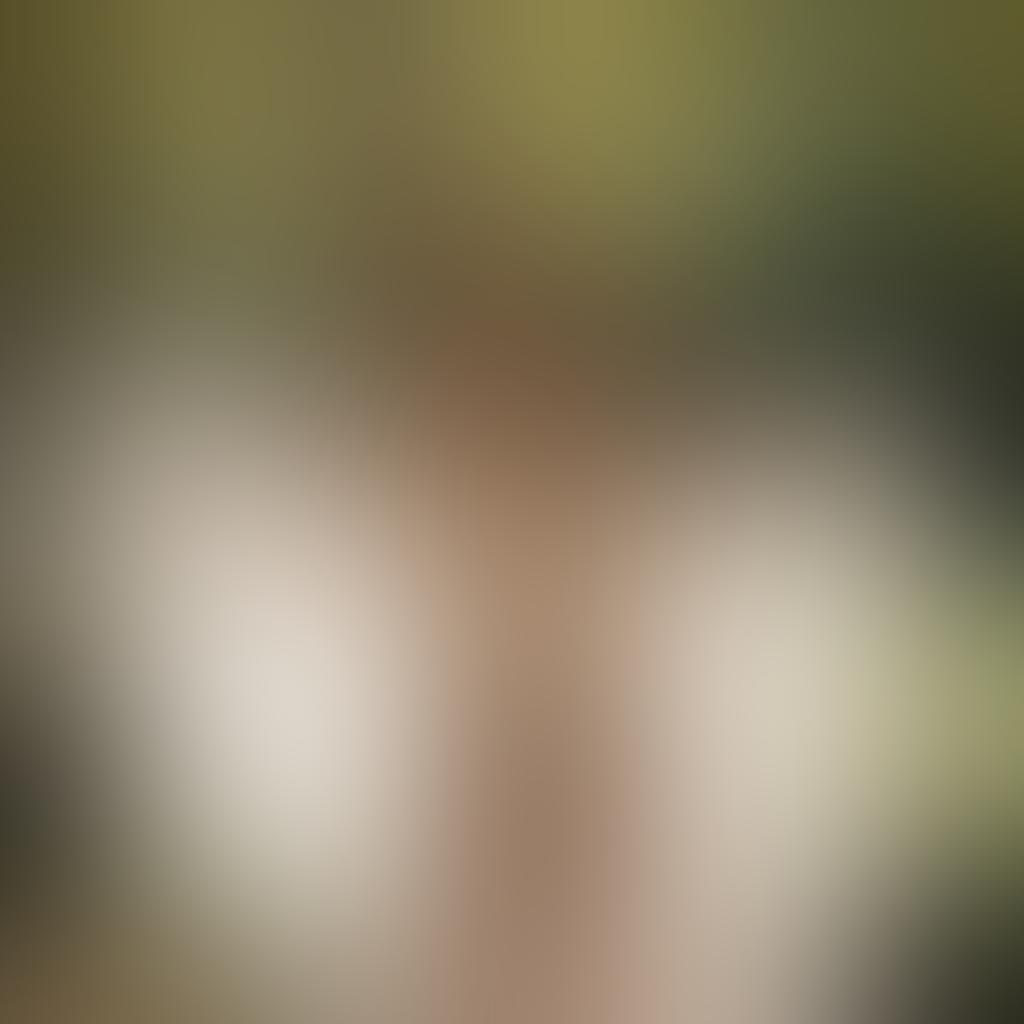 A powerful and graceful woman standing in a serene natural setting, embodying beauty and empowerment, her body embraced by soft flowing fabrics that accentuate her natural curves. Ethereal light filters through the trees, casting delicate shadows, while flowers bloom around her. The scene captures a spirit of confidence and intimacy, promoting a positive view of nudity and self-love. warm color tones. soft focus. artistic photography.